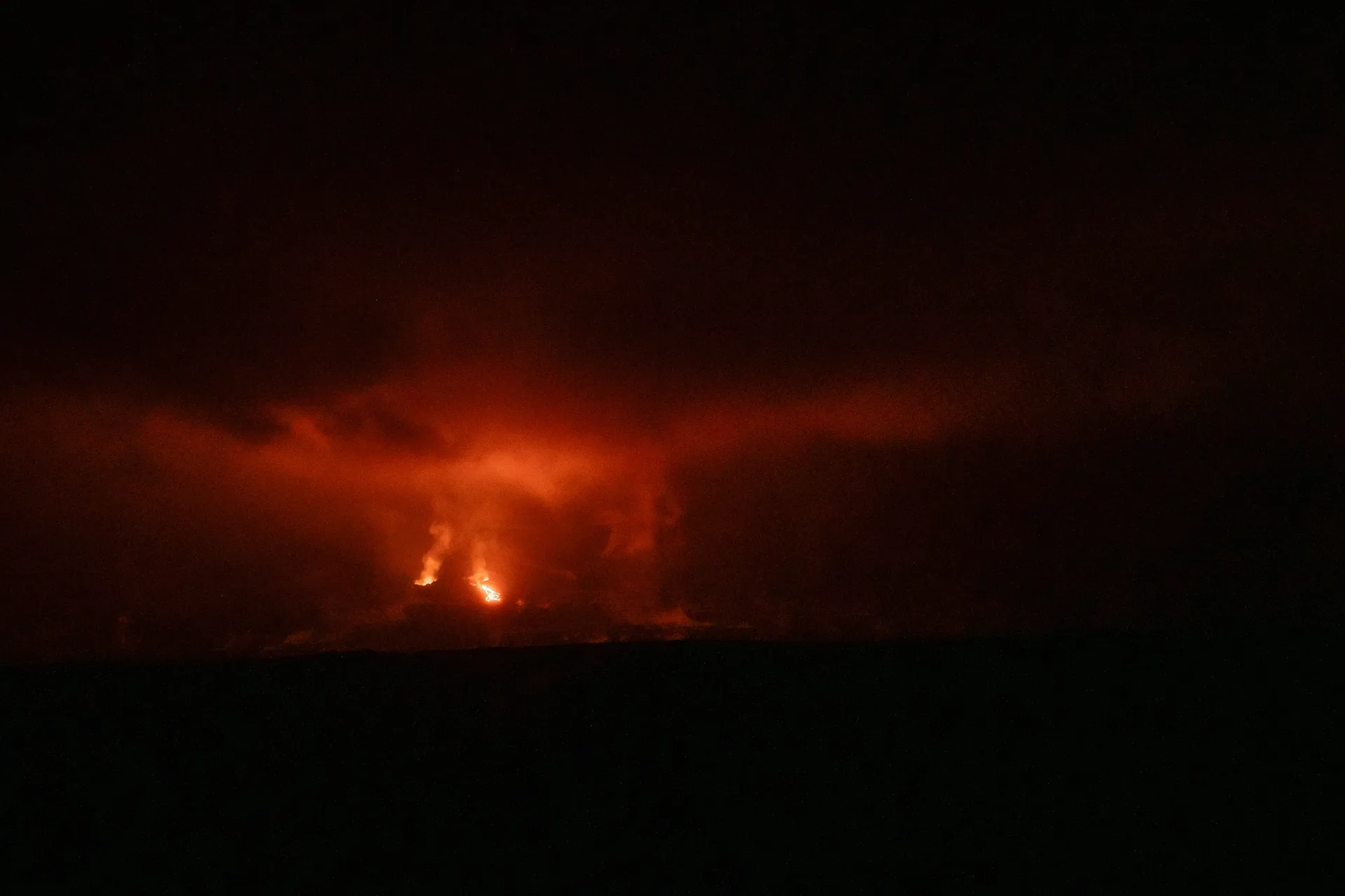An active eruption lights up the night sky from miles away.